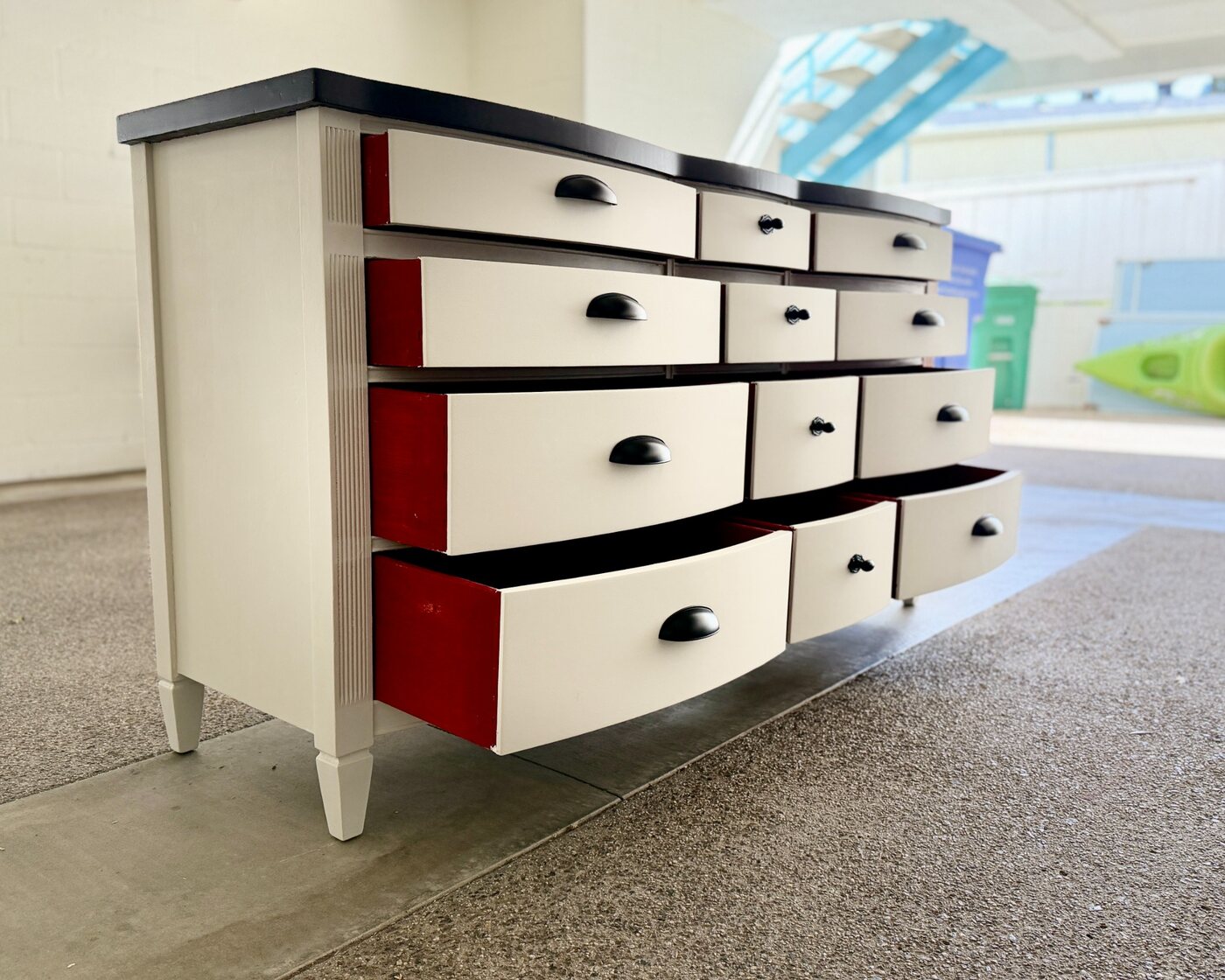 Vanilla Noir with drawers open to reveal red interiors